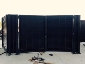 A black louver screen system with fire code compatible screen doors