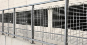 A parking garage protected from traffic with aluminum bar grating panels