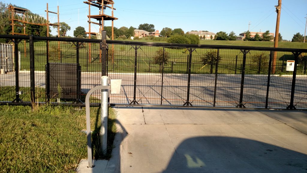 Automated black cantilever gate with wire mesh, sliding gate operator and keypad entry device