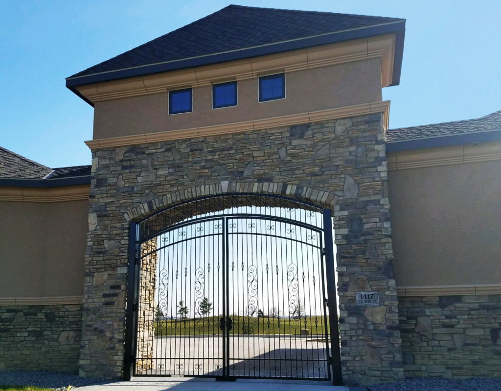 Double swing driveway gate installed into a residential wall